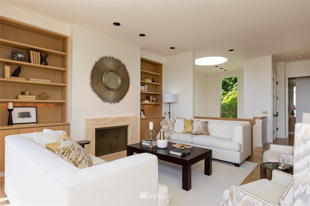 104 Highland Drive Seattle, WA 98109 - Photo 12 of 39 a living room with furniture a fireplace and a large window