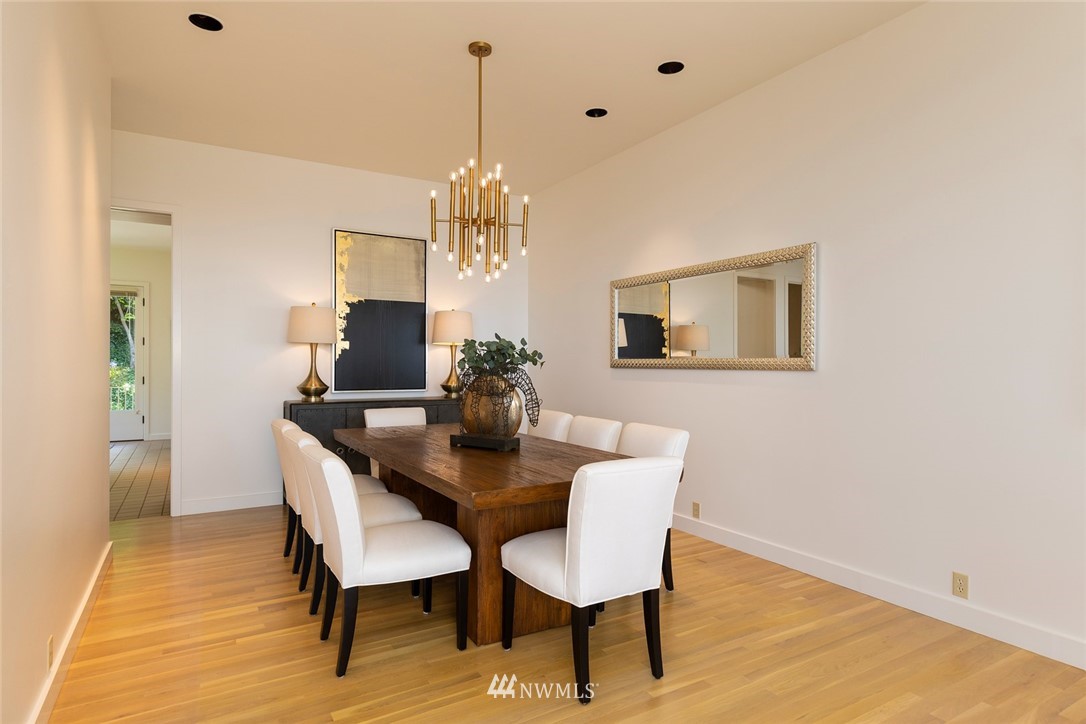 104 Highland Drive Seattle, WA 98109 - Photo 14 of 39 a view of a dining room with furniture a chandelier and wooden floor