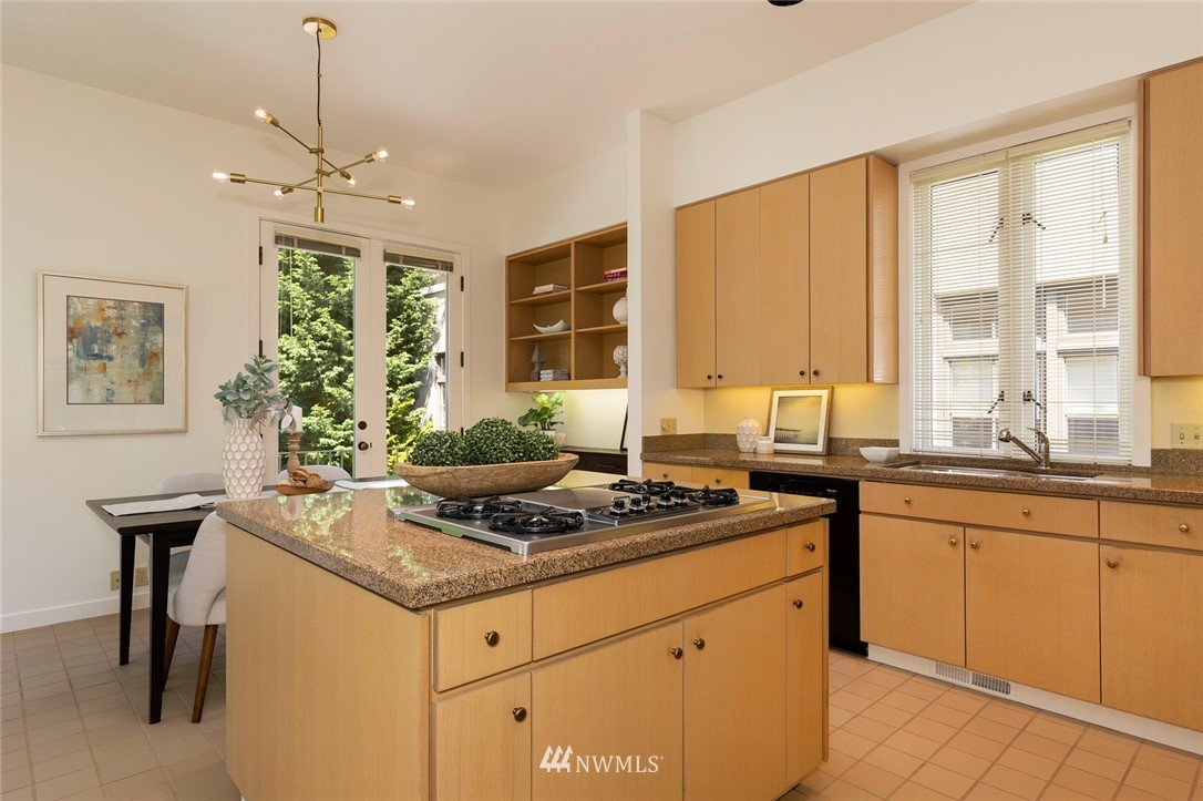 104 Highland Drive Seattle, WA 98109 - Photo 15 of 39 a kitchen with stainless steel appliances granite countertop a stove a sink and a refrigerator