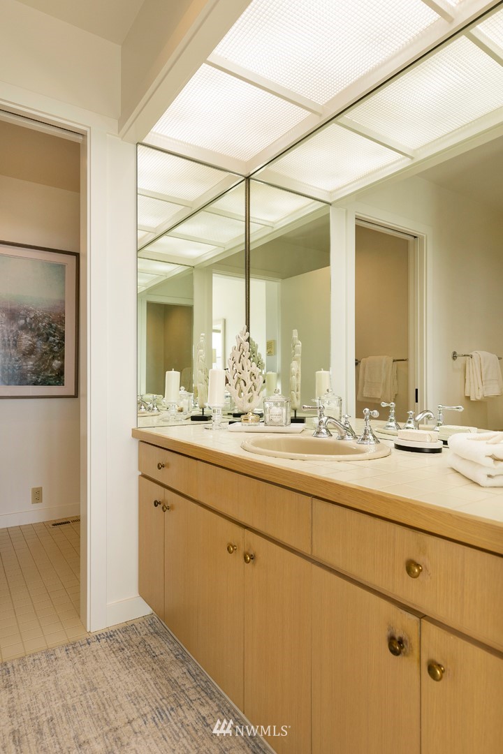 104 Highland Drive Seattle, WA 98109 - Photo 23 of 39 a bathroom with a sink and a mirror