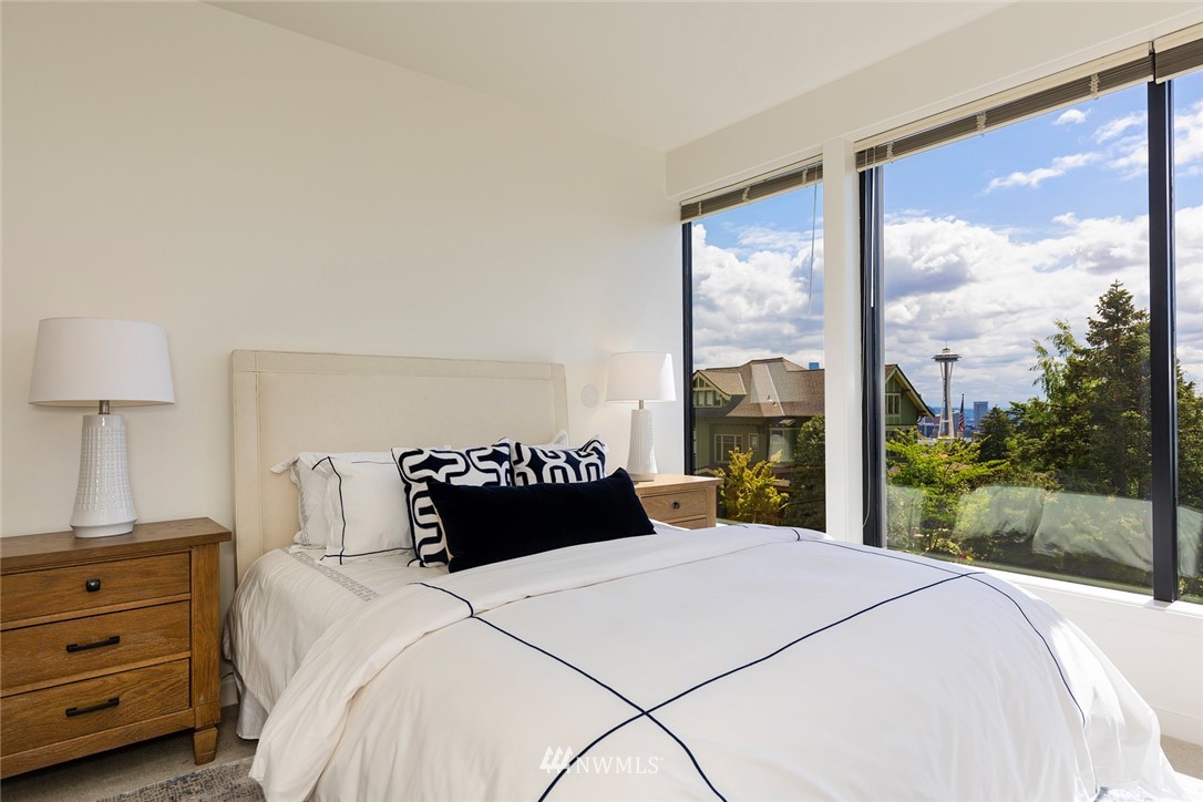 104 Highland Drive Seattle, WA 98109 - Photo 25 of 39 a bedroom with a large bed and a window