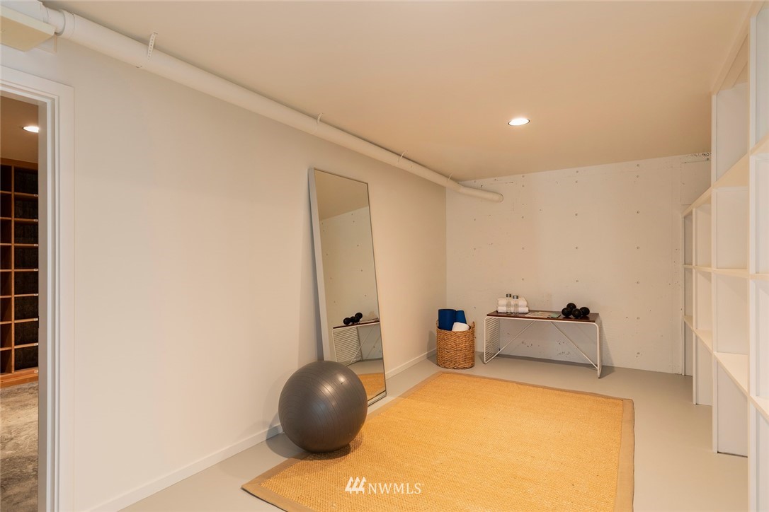 104 Highland Drive Seattle, WA 98109 - Photo 32 of 39 a bedroom with a bed and a chandelier