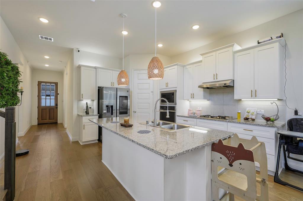 3603 Scotsman Road Sachse, TX 75048 - Photo 9 of 33 a kitchen with refrigerator and cabinets