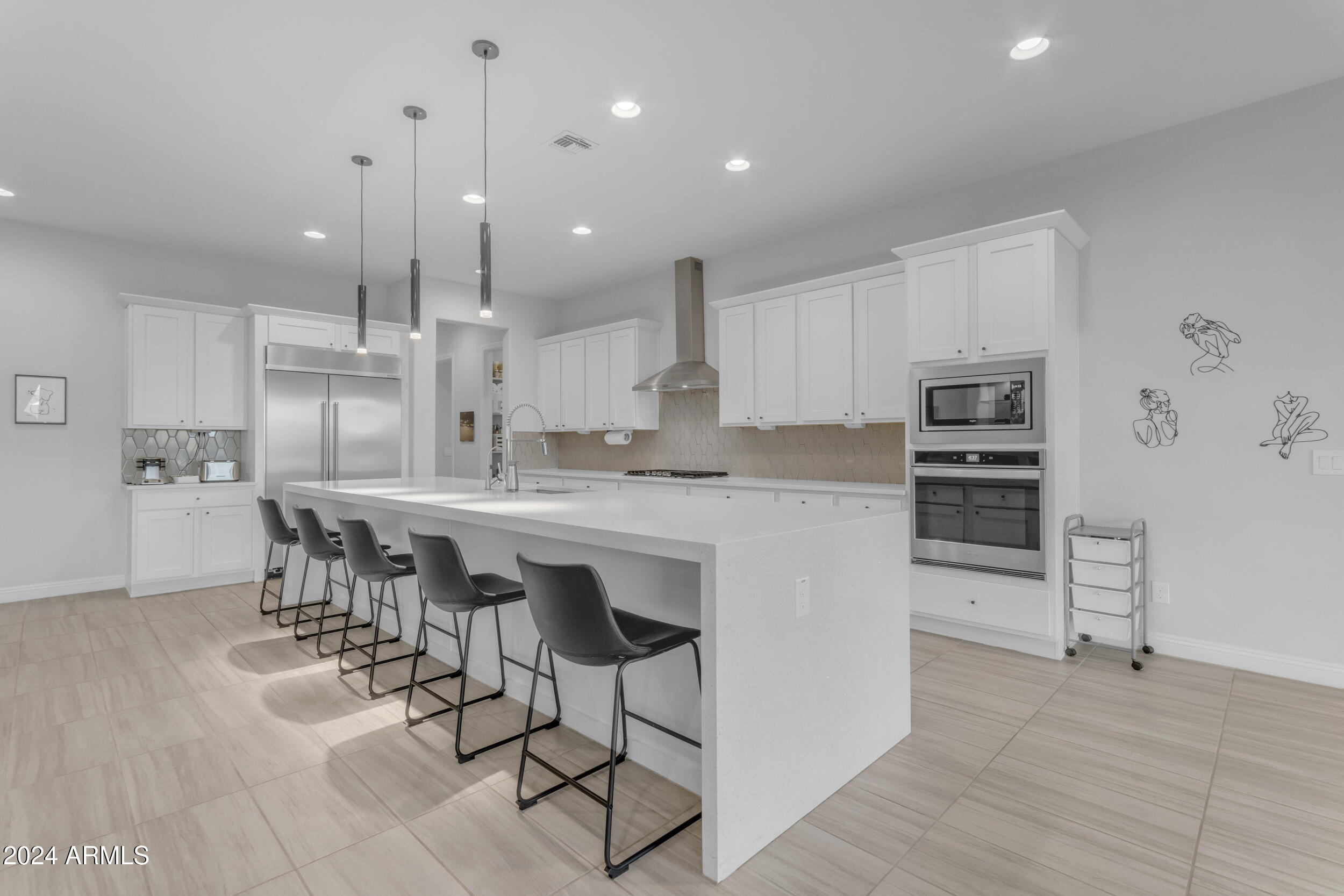22678 East Stacey Road Queen Creek, AZ 85142 - Photo 25 of 101 a kitchen with kitchen island a stove a table and chairs in it
