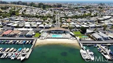 an aerial view of a house with yard swimming pool and trees in the background