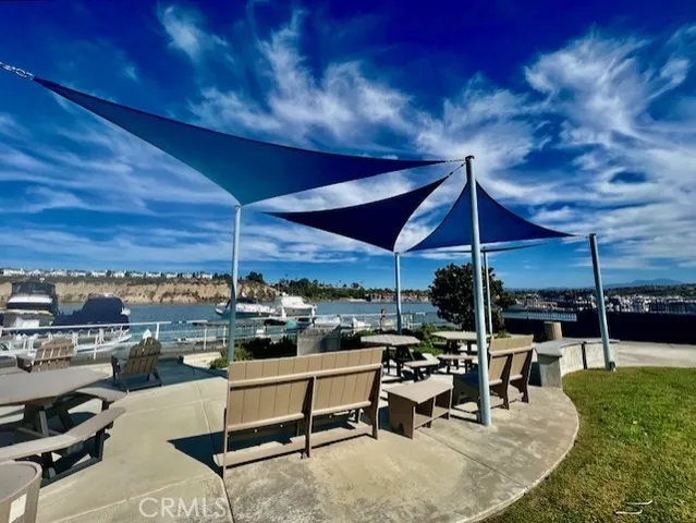 a view of a patio with a table and chairs under an umbrella