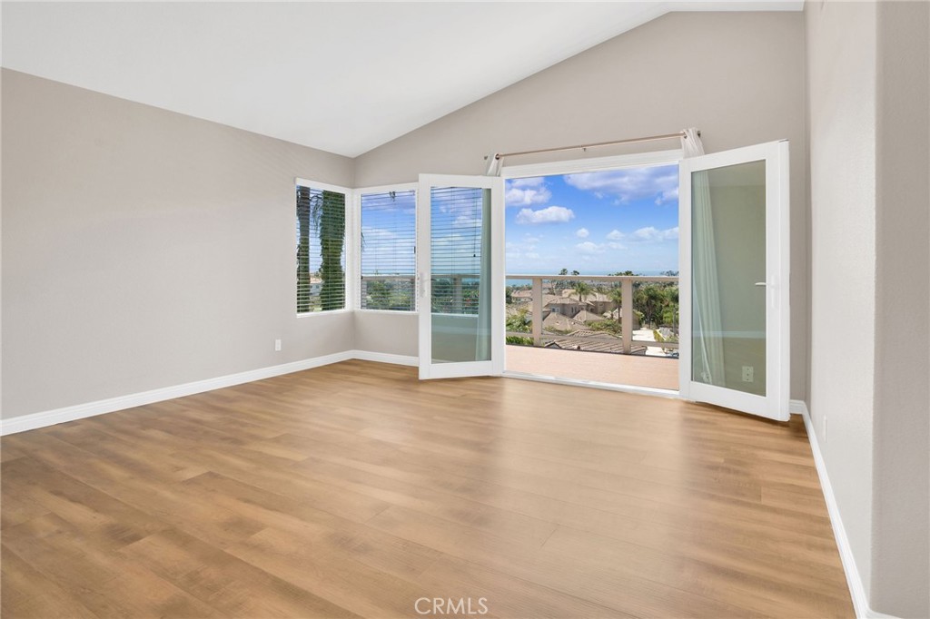 33 Dauphin Dana Point, CA 92629 - Photo 12 of 26 an empty room with wooden floor and windows