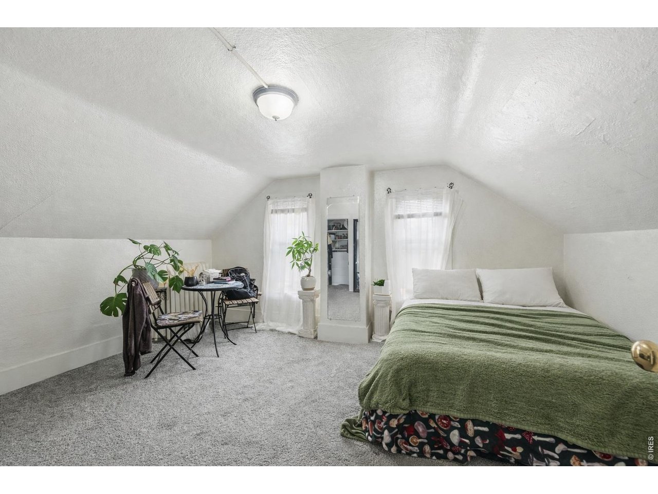 856 10th Street Boulder, CO 80302 - Photo 17 of 28 a bedroom with a bed and a chair
