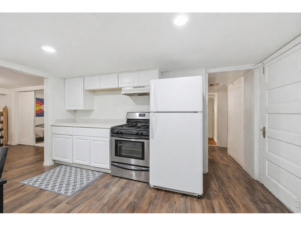 856 10th Street Boulder, CO 80302 - Photo 21 of 28 a kitchen with granite countertop a refrigerator and a stove top oven
