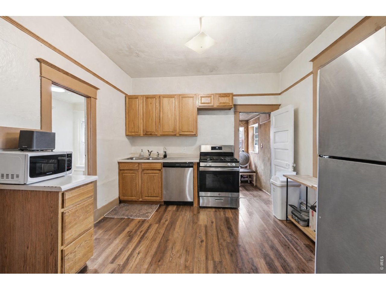 856 10th Street Boulder, CO 80302 - Photo 4 of 28 a kitchen with a refrigerator wooden floor and a stove top oven