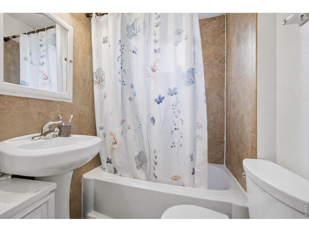 856 10th Street Boulder, CO 80302 - Photo 10 of 28 a bathroom with a sink a toilet and a mirror