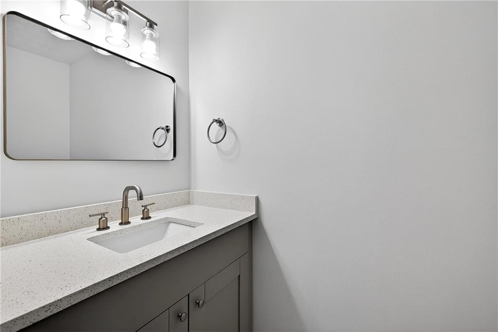 6716 Colchester Place Northwest Norcross, GA 30093 - Photo 16 of 23 a bathroom with a sink and a mirror