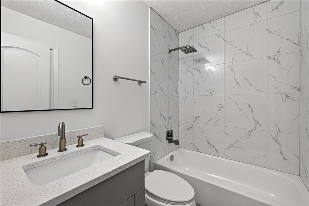6716 Colchester Place Northwest Norcross, GA 30093 - Photo 18 of 23 a bathroom with a sink toilet and shower