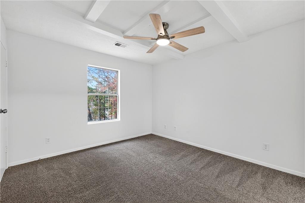 6716 Colchester Place Northwest Norcross, GA 30093 - Photo 19 of 23 an empty room with a window and a fan