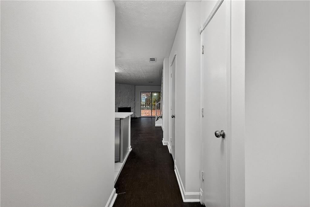 6716 Colchester Place Northwest Norcross, GA 30093 - Photo 4 of 23 a view of a hallway with a livingroom with furniture and stairs