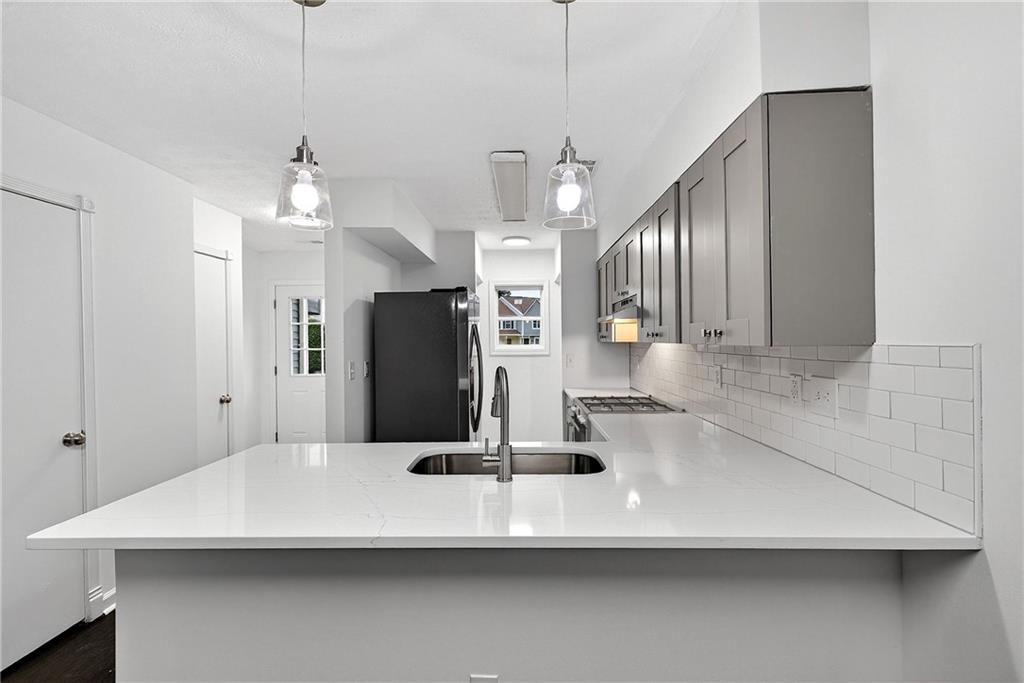 6716 Colchester Place Northwest Norcross, GA 30093 - Photo 5 of 23 a view of a kitchen with a sink and refrigerator