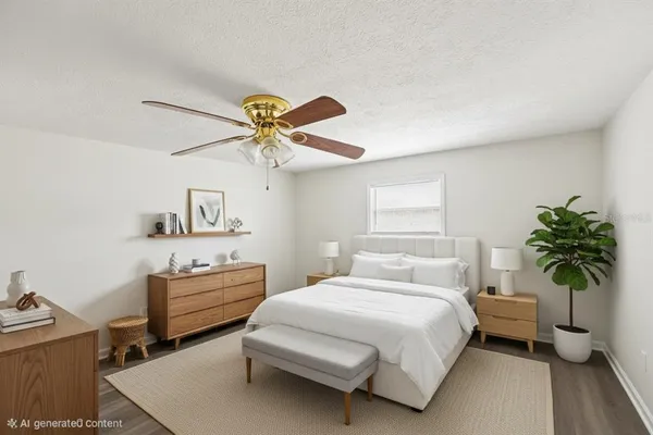 a bedroom with a bed and a potted plant
