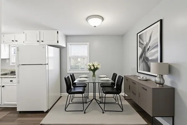 a view of kitchen with furniture and refrigerator