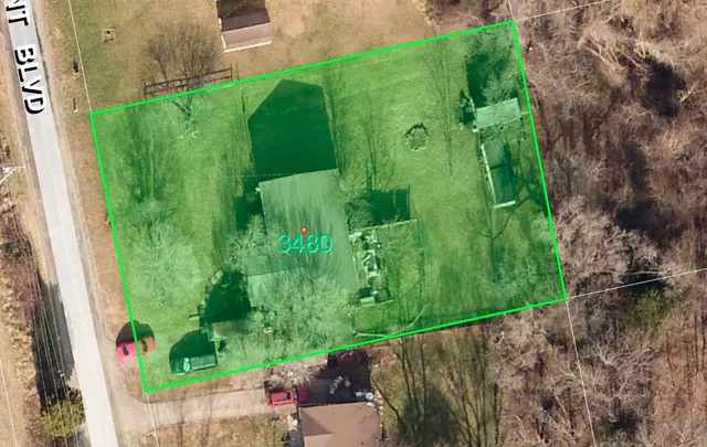 a view of a house with a yard covered in snow