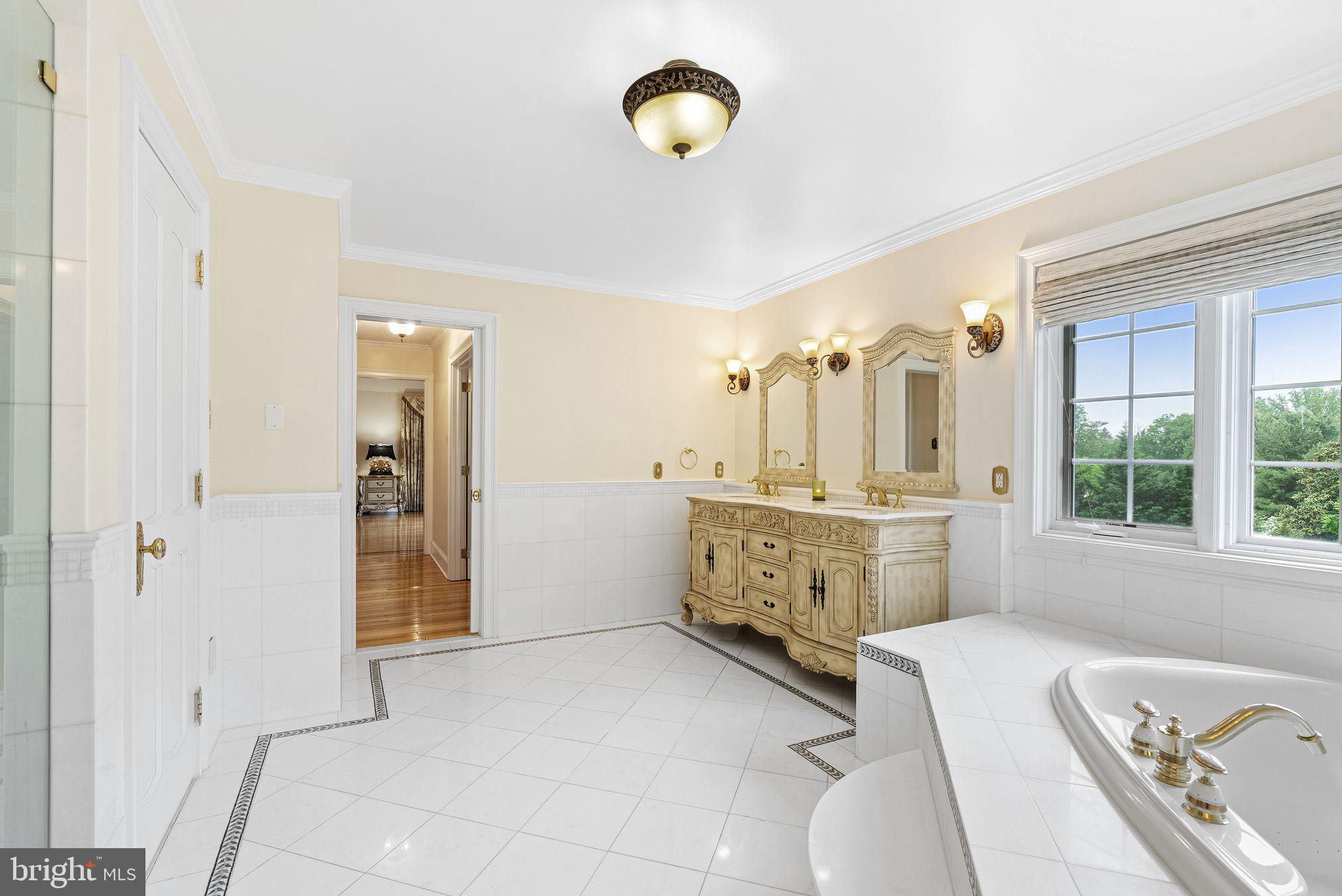 2 Greystone Circle Newtown Square, PA 19073 - Photo 22 of 57 a bathroom with a double vanity sink a mirror and a bathtub