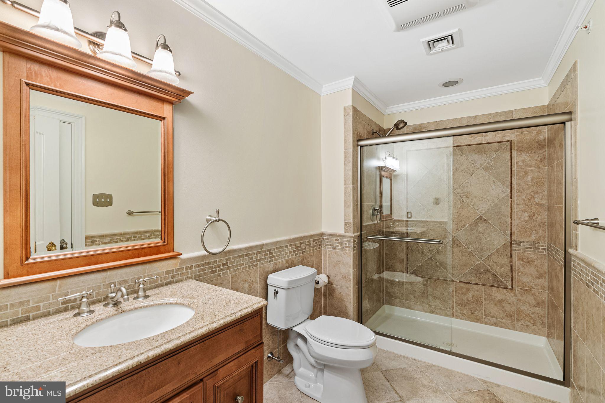 2 Greystone Circle Newtown Square, PA 19073 - Photo 37 of 57 a bathroom with a granite countertop sink toilet mirror and shower