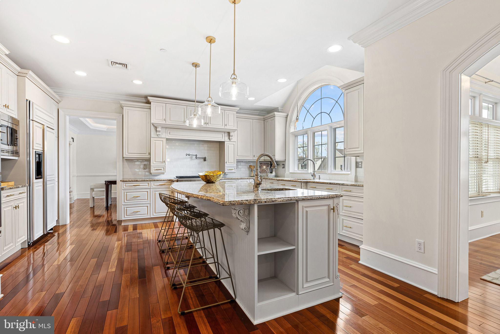 2 Greystone Circle Newtown Square, PA 19073 - Photo 9 of 57 a kitchen with stainless steel appliances granite countertop a stove refrigerator and a wooden floor