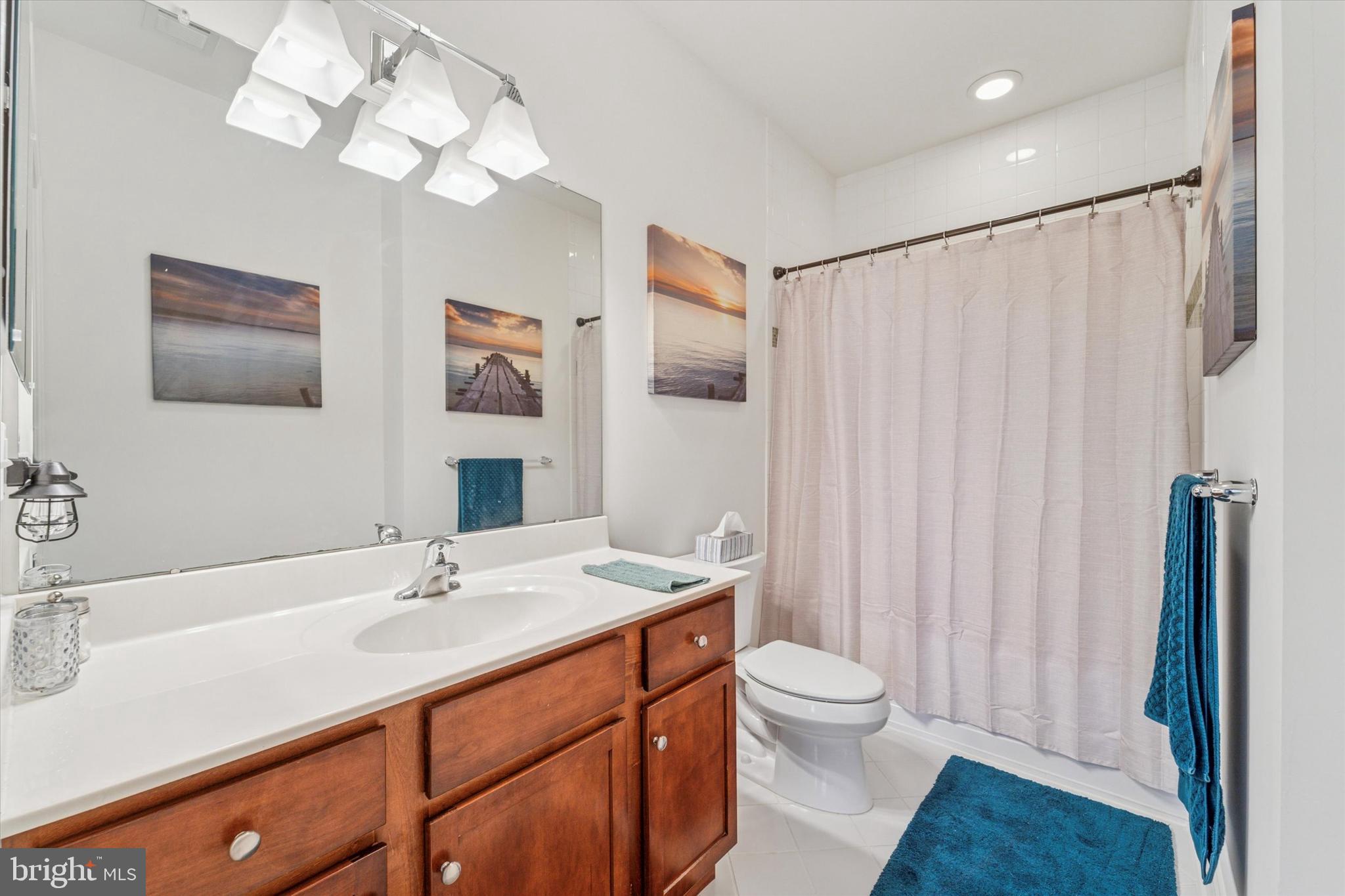 2346 Highway 33, Unit 302 Robbinsville, NJ 08691 - Photo 12 of 21 a bathroom with a double vanity sink toilet and shower