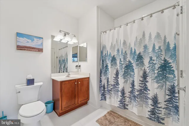 a view of bathroom with a toilet sink and mirror