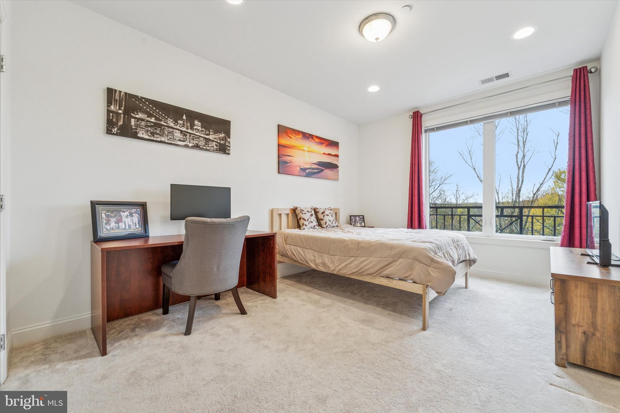 2346 Highway 33, Unit 302 Robbinsville, NJ 08691 - Photo 15 of 21 a bed room with a bed and a chair