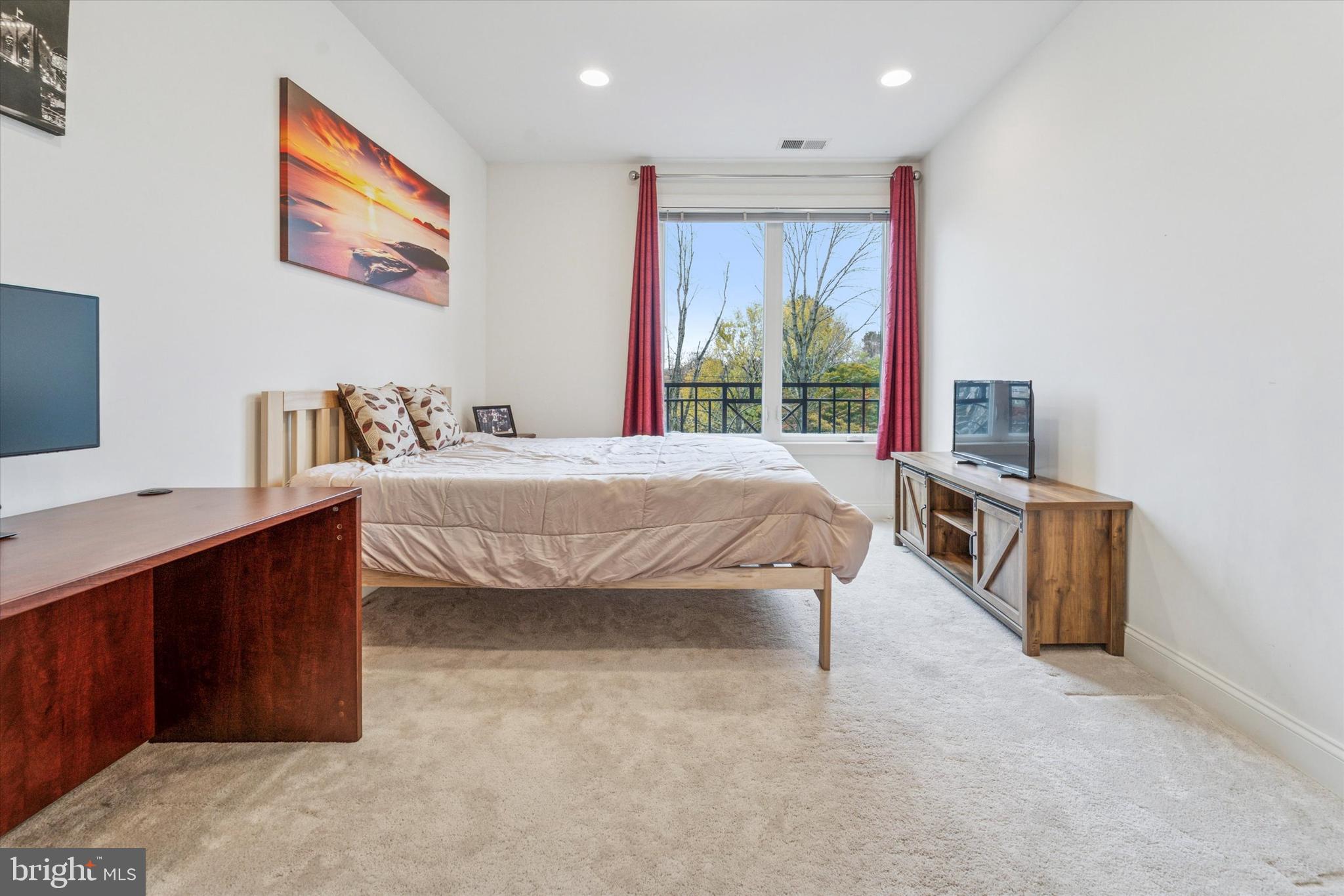 2346 Highway 33, Unit 302 Robbinsville, NJ 08691 - Photo 16 of 21 a bedroom with a bed and a flat screen tv