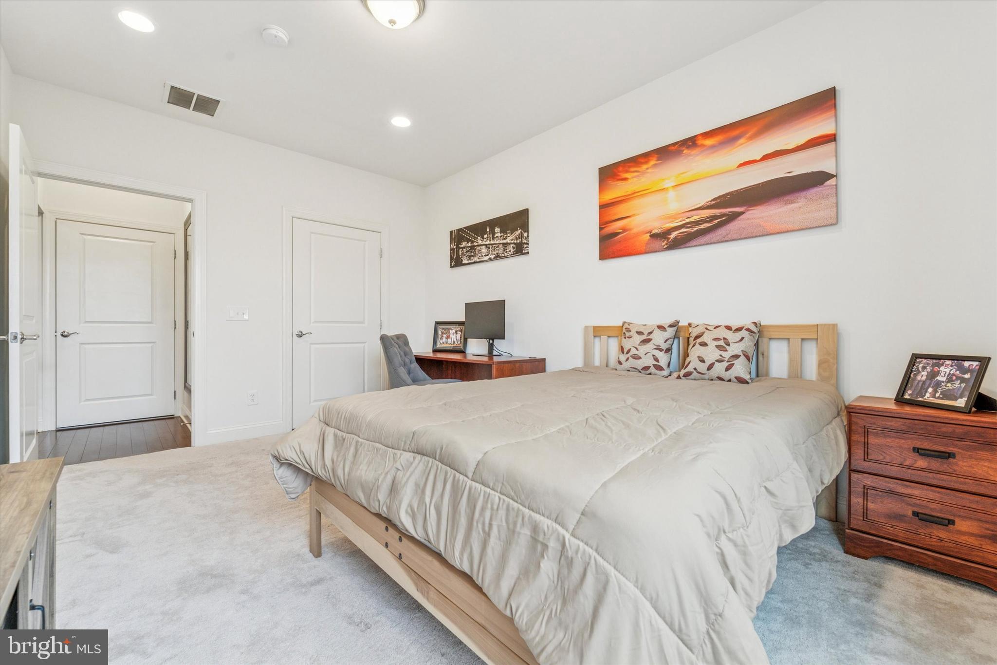 2346 Highway 33, Unit 302 Robbinsville, NJ 08691 - Photo 17 of 21 a bedroom with a bed and a painting on the wall