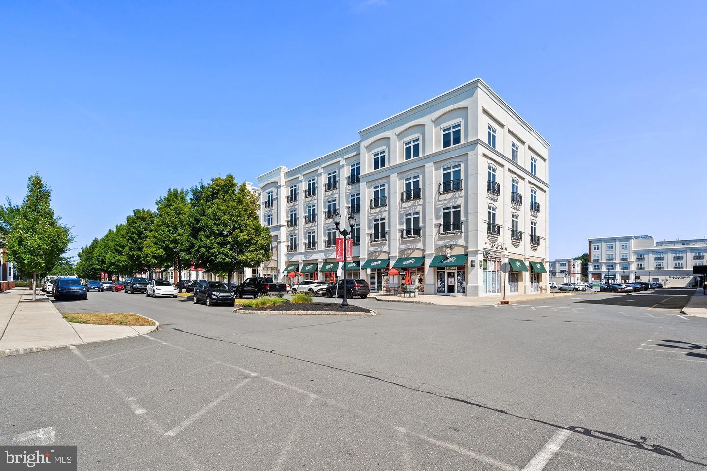2346 Highway 33, Unit 302 Robbinsville, NJ 08691 - Photo 20 of 21 a view of a street with cars and a buildings