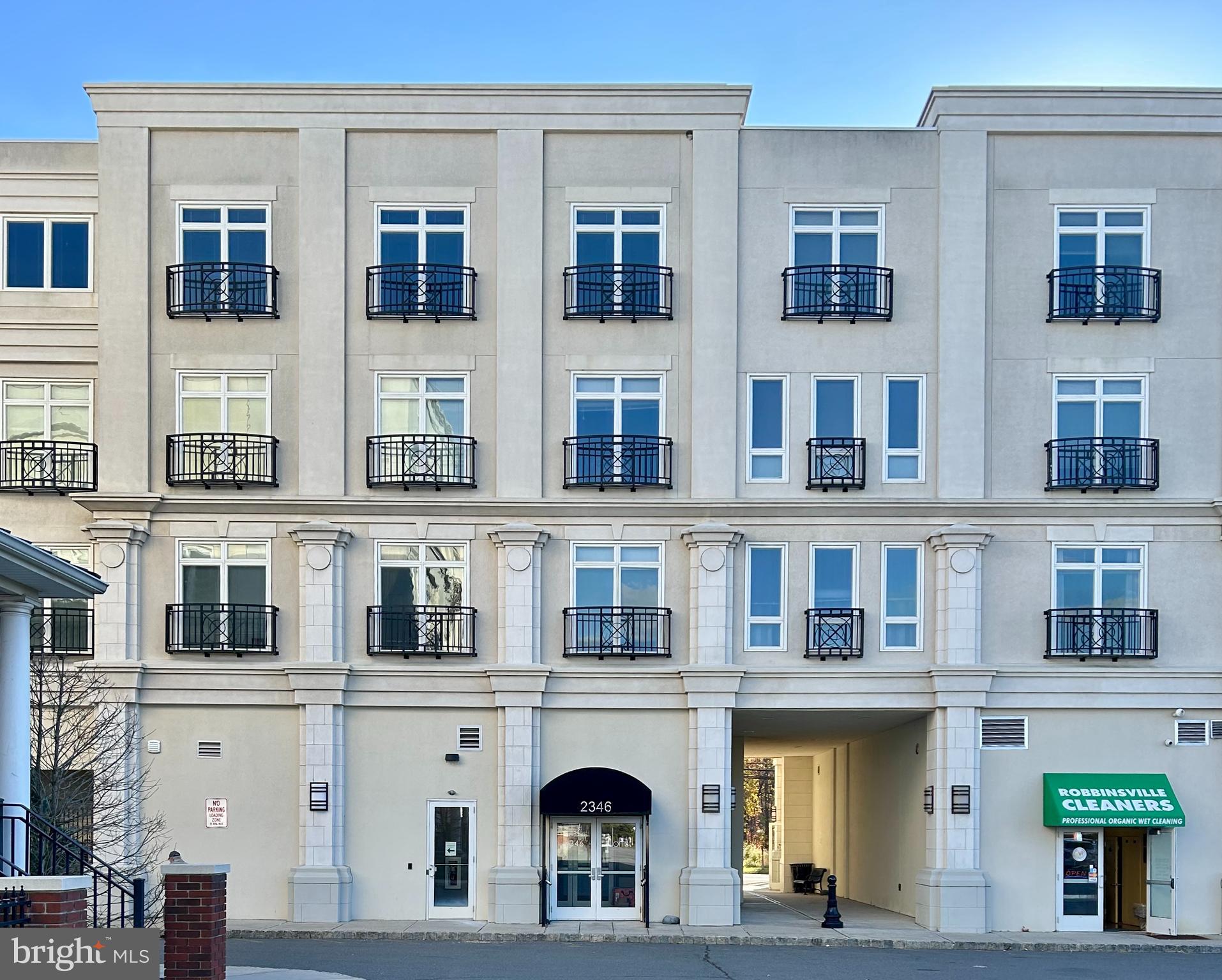 2346 Highway 33, Unit 302 Robbinsville, NJ 08691 - Photo 2 of 21 a view of building with a lot of windows