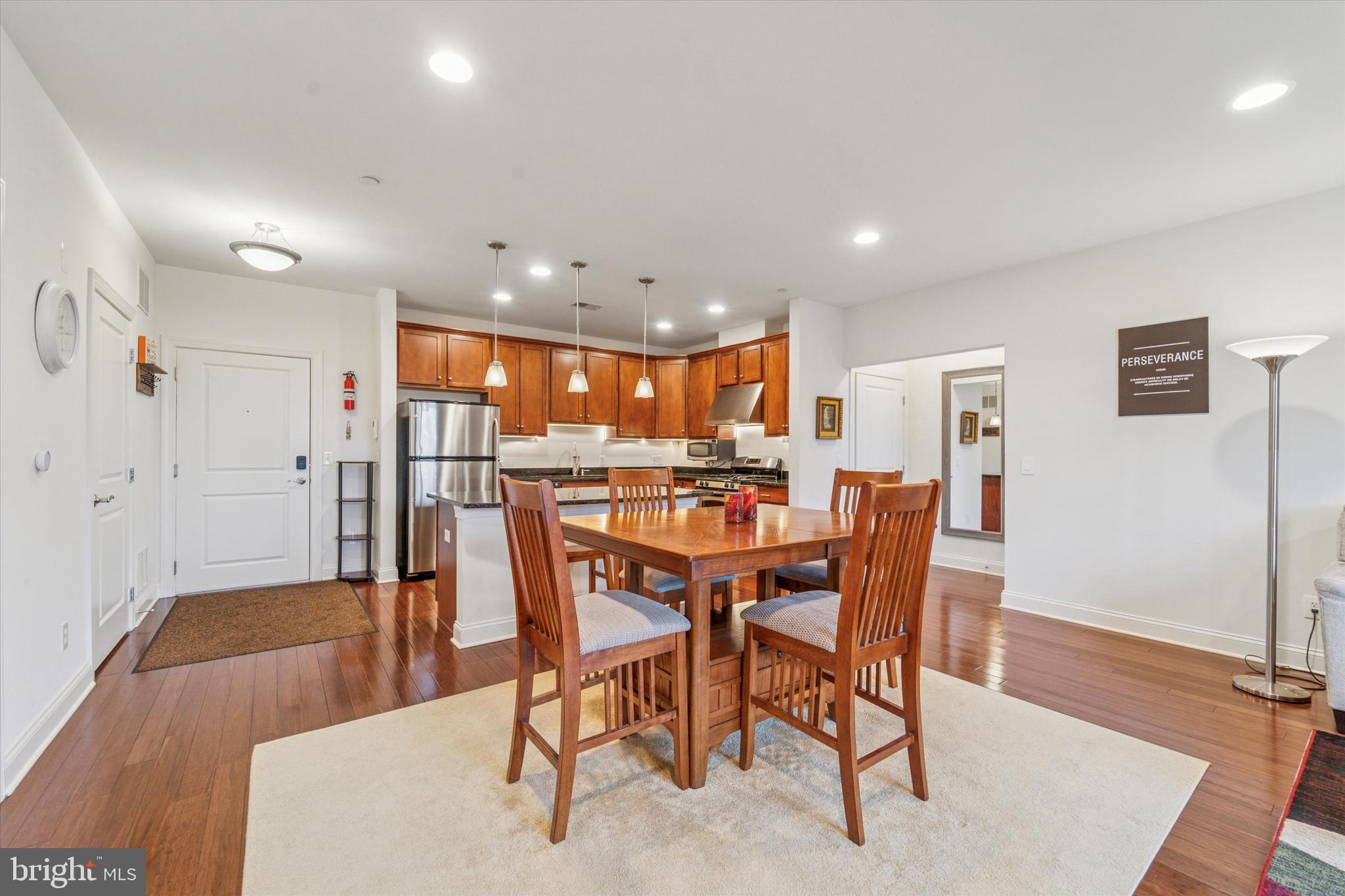 2346 Highway 33, Unit 302 Robbinsville, NJ 08691 - Photo 6 of 21 a dining room with furniture and wooden floor