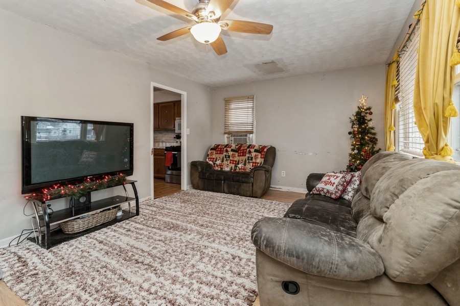 2305 Marmion Avenue Joliet, IL 60436 - Photo 3 of 10 a living room with furniture and a flat screen tv
