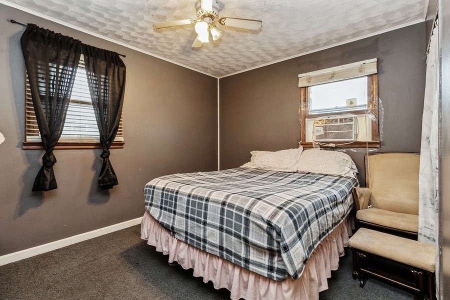 2305 Marmion Avenue Joliet, IL 60436 - Photo 6 of 10 a bedroom with a bed and window