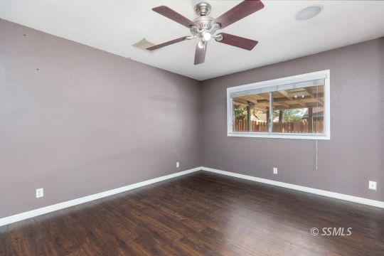 613 South Silver Ridge Street Ridgecrest, CA 93555 - Photo 21 of 26 a view of a big room with wooden floor and windows