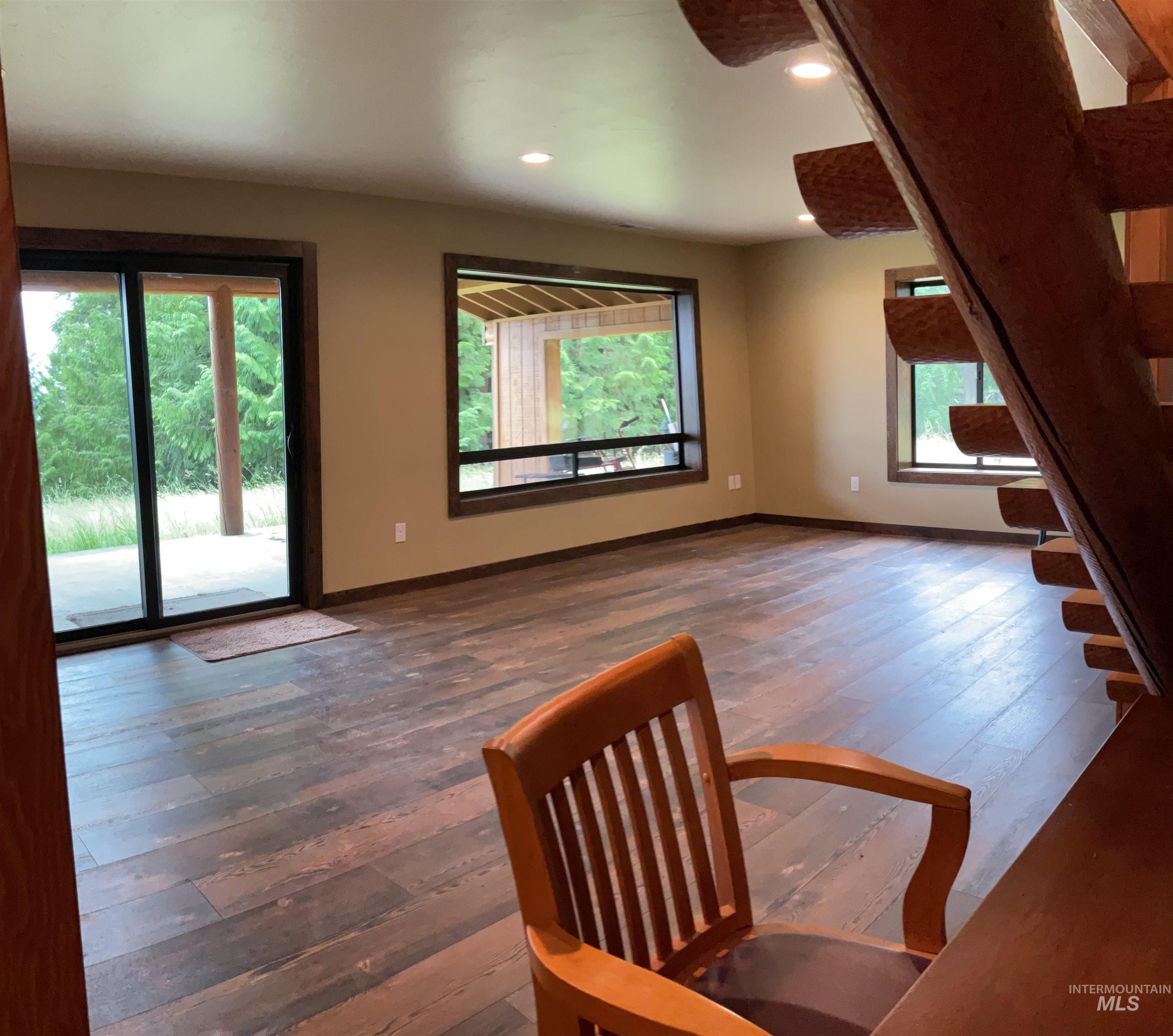 6125 Freeman Creek Road Lenore, ID 83541 - Photo 35 of 44 Room featuring wood-finish flooring, recessed lighting, and a window with dark wood trim