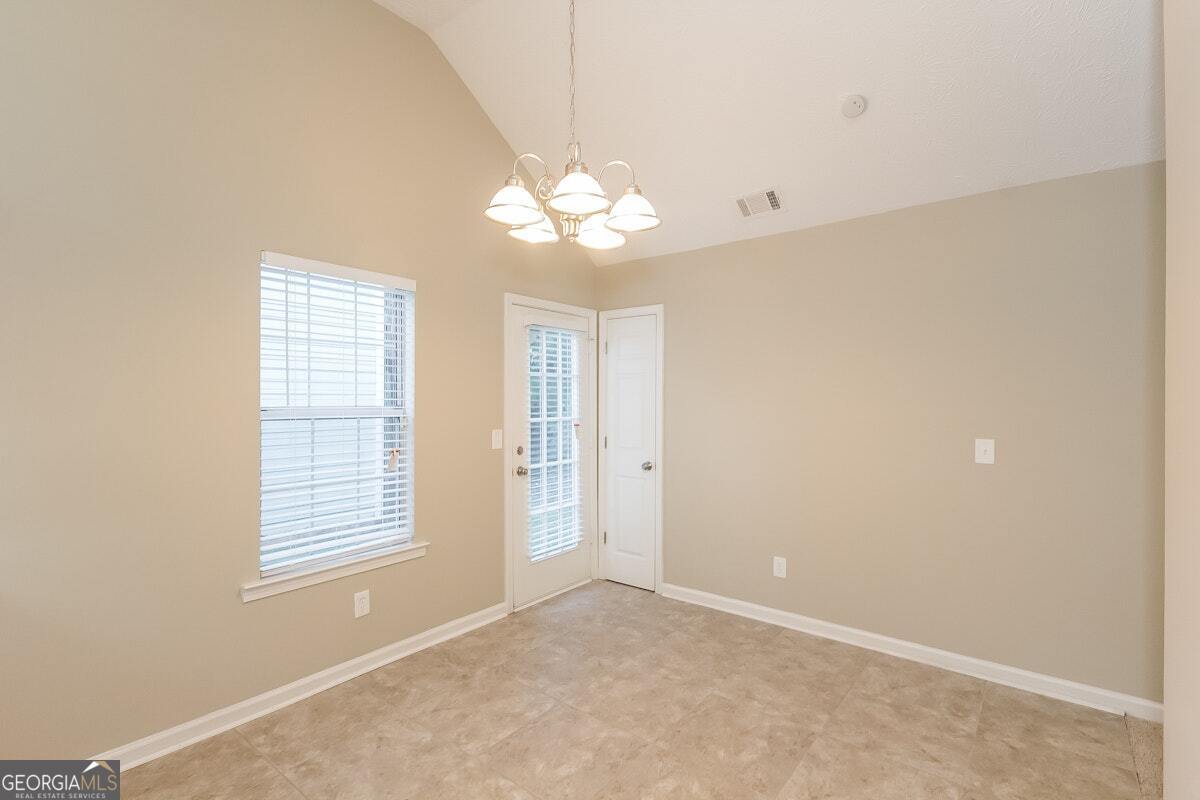 1136 Oakwood Manor Court Decatur, GA 30032 - Photo 12 of 15 a view of an empty room with a window
