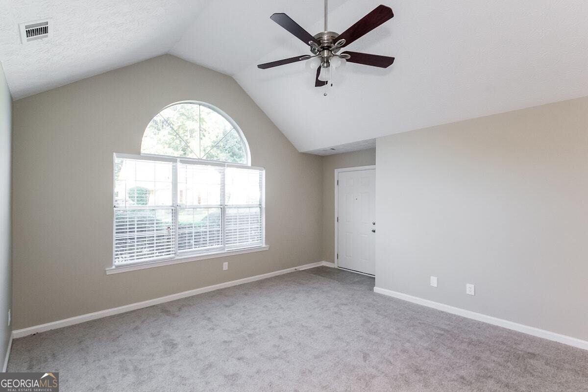 1136 Oakwood Manor Court Decatur, GA 30032 - Photo 14 of 15 an empty room with a window and a fan