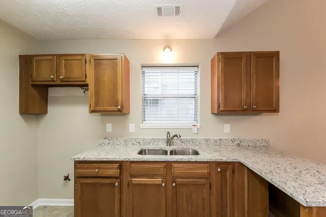 a kitchen with a sink and cabinets