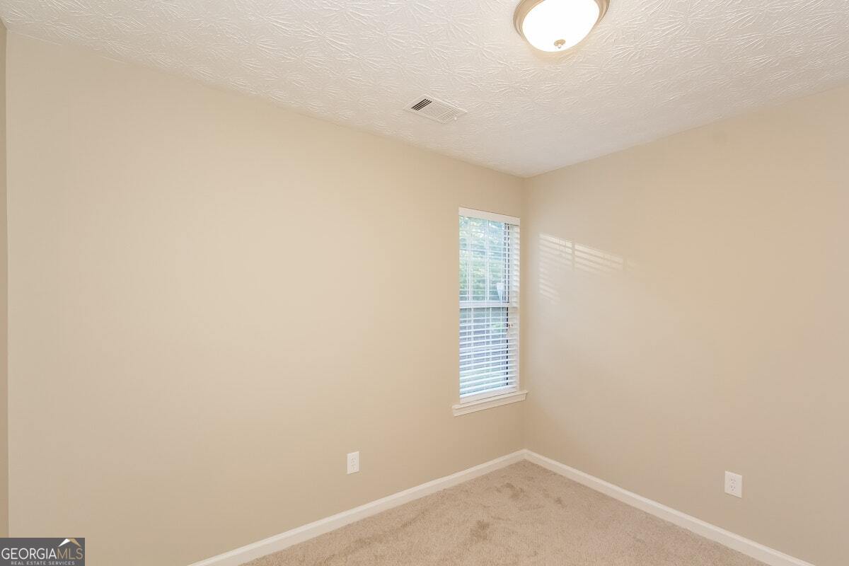 1136 Oakwood Manor Court Decatur, GA 30032 - Photo 9 of 15 a view of an empty room with a window