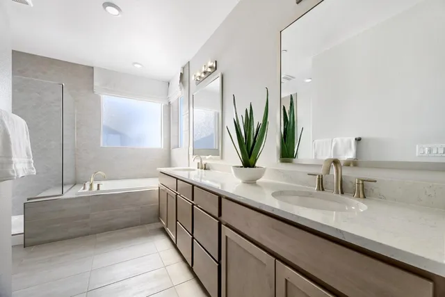 a bathroom with a double vanity sink and a bathtub