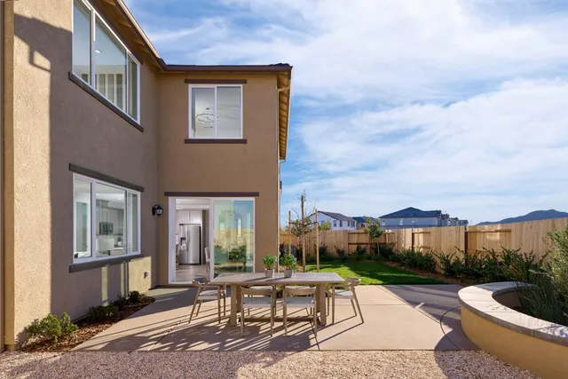 a front view of a house with garden and porch