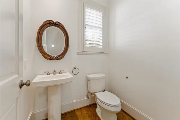 a bathroom with a toilet a sink and a mirror