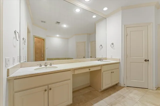 a bathroom with a double vanity sink and a mirror