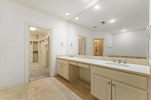 a spacious bathroom with a shower sink and mirror
