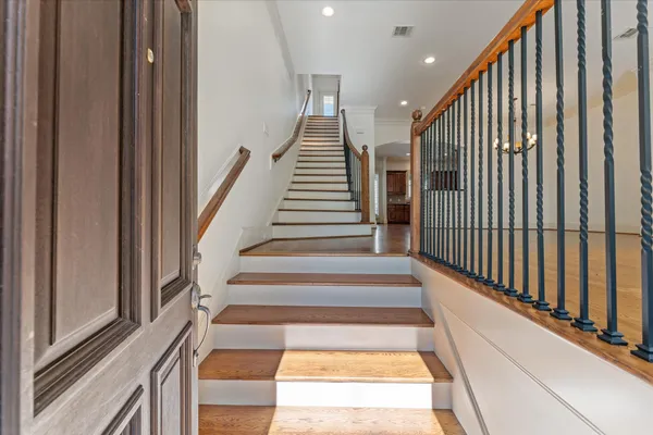 a view of entryway and hall with wooden floor