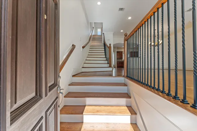 a view of entryway and hall with wooden floor