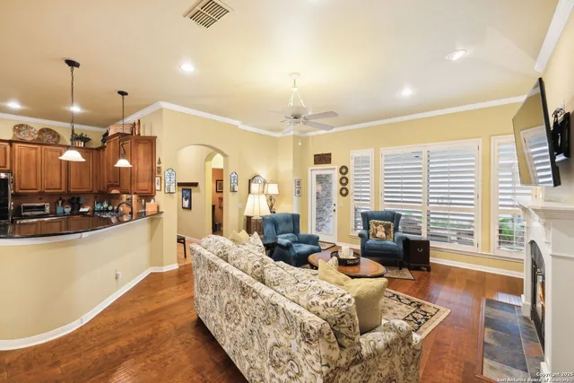 a living room with furniture a fireplace and a flat screen tv